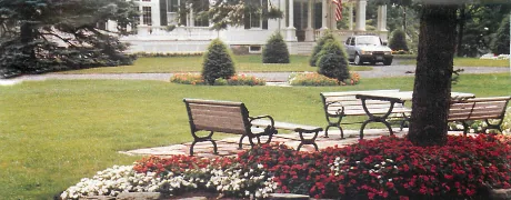 Picnic table and chairs in front of a mansion
